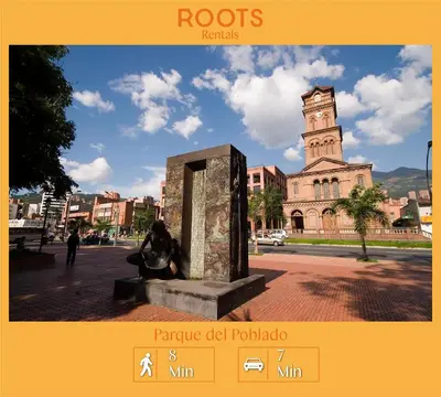 a statue in front of a building with a clock tower at Cómodo aparta suite en zona Poblado Medellín M101 By Roots Rentals in Medellín