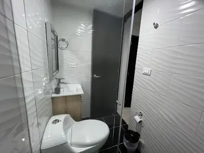 a bathroom with a white toilet and a sink at HABITACION AMOBLADA SECTOR LAURELES-ESTADIO #1 Madrid in Medellín