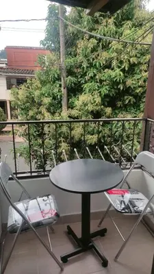 a table and two chairs on a balcony at HABITACION AMOBLADA SECTOR LAURELES-ESTADIO hasta 3 personas Santorini in Medellín