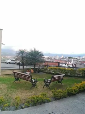 two benches in a park with a view of a city at GIBRALTAR in Manizales