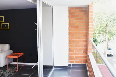 a glass door in a room with a brick wall at Espectacular apt de 3 habitaciones deluxe! in Envigado