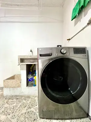 a washing machine sitting in a laundry room at Alojamiento económico en Medellín - NID104 By Roots Rentals in Medellín