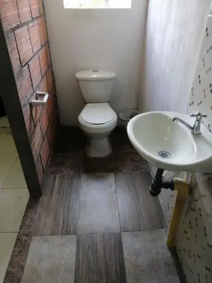a bathroom with a toilet and a sink at Casa de relajación low cost! in La Dorada