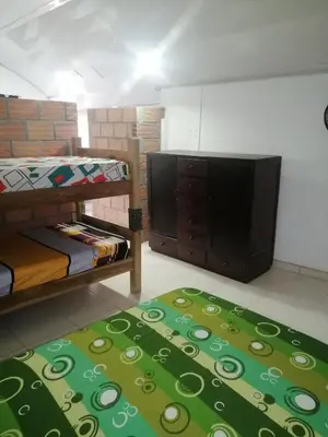 a room with two bunk beds and a flat screen tv at Casa de relajación low cost! in La Dorada