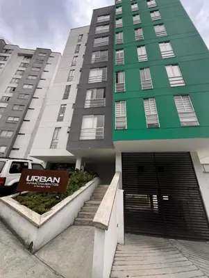 a green and white building with a door and stairs at Bonito apartaestudio /manizales in Manizales