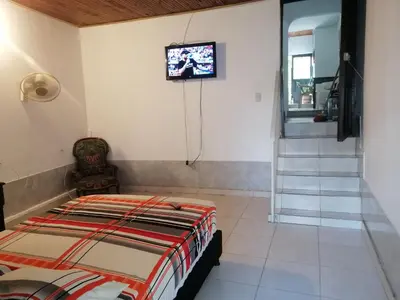 a bedroom with a bed and a tv on the wall at Casa lowcost relajación in La Dorada